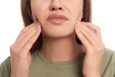 Photo of Young woman suffering from toothache on white background, closeup