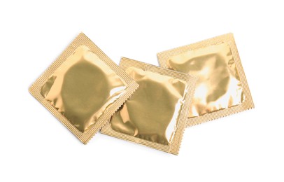 Photo of Condom packages on white background, top view. Safe sex