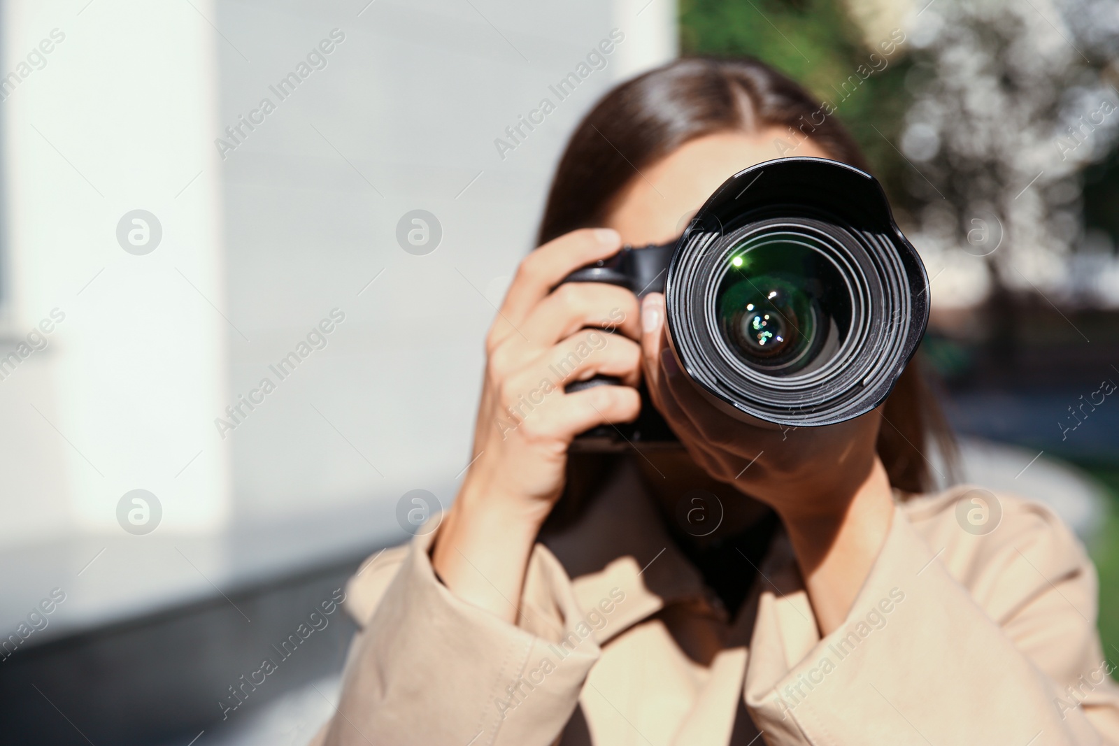 Photo of Private detective with camera spying on city street