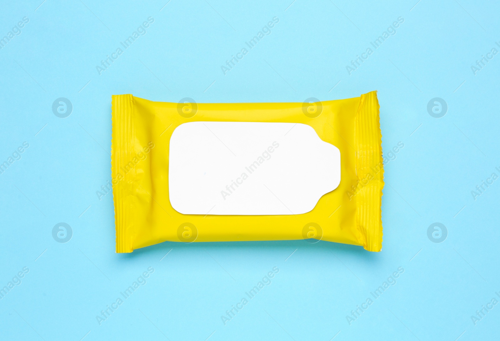 Photo of Wet wipes flow pack on light blue background, top view