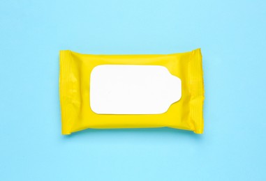 Wet wipes flow pack on light blue background, top view