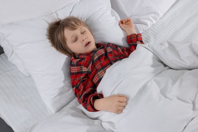 Photo of Little boy snoring while sleeping in bed