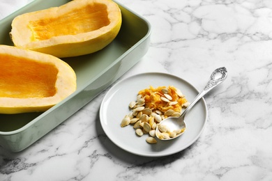 Composition with spaghetti squash seeds and raw vegetable on marble table