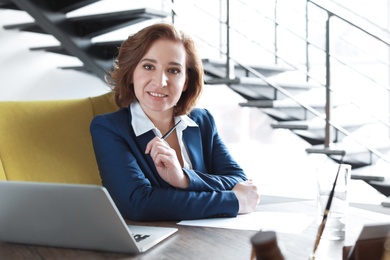 Female lawyer working at table in office