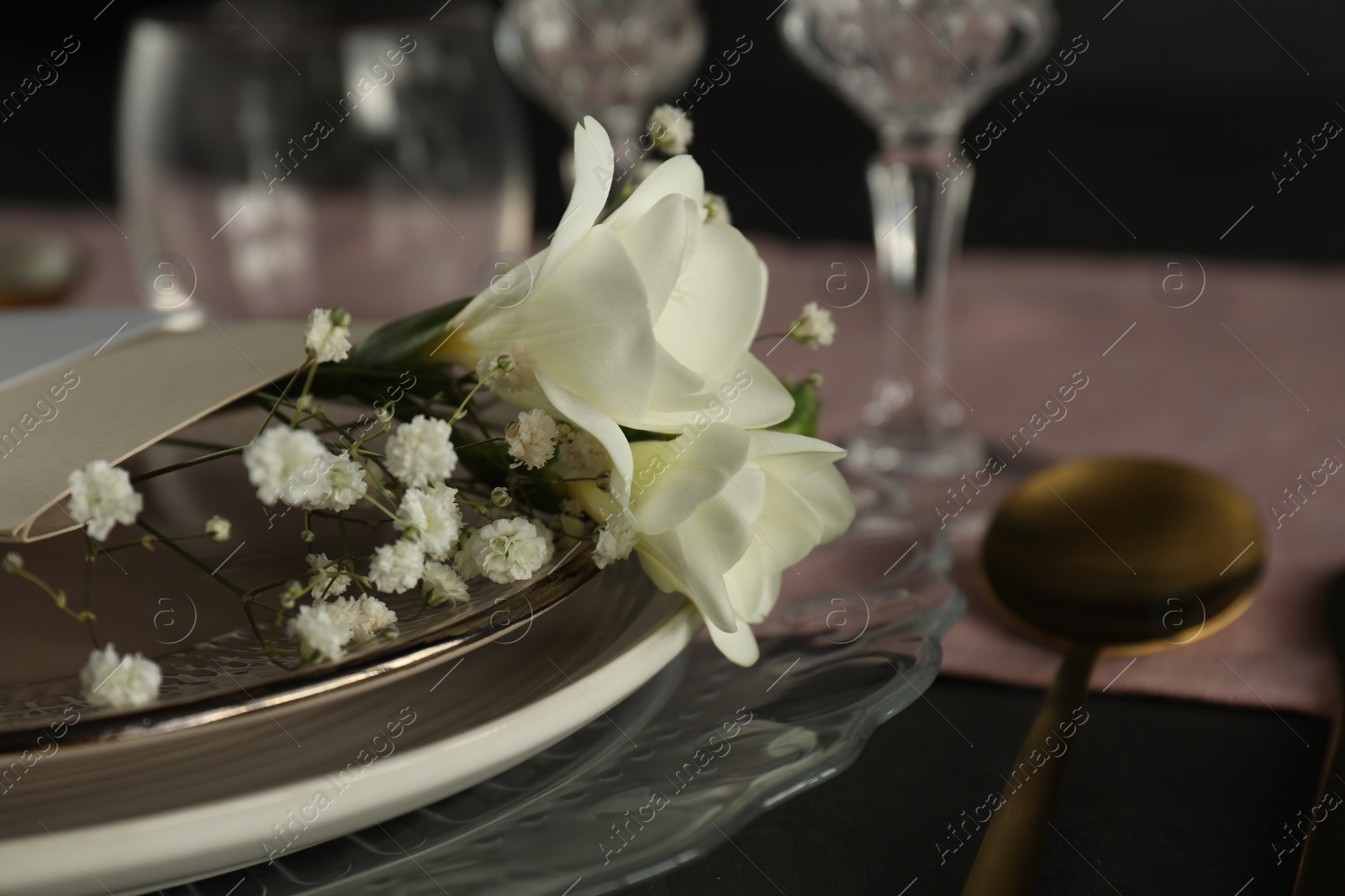 Photo of Stylish table setting with floral decor, closeup. Space for text