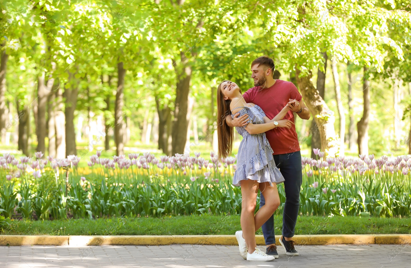 Photo of Happy young couple in green park on sunny spring day