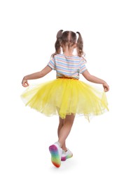 Photo of Cute little girl in tutu skirt dancing on white background, back view