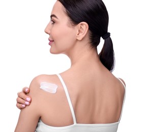 Photo of Beautiful woman with smear of body cream on her shoulder against white background