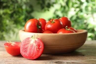 Photo of Fresh ripe red tomatoes on wooden table