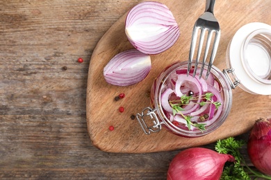 Photo of Flat lay composition with jar of pickled onions on wooden table