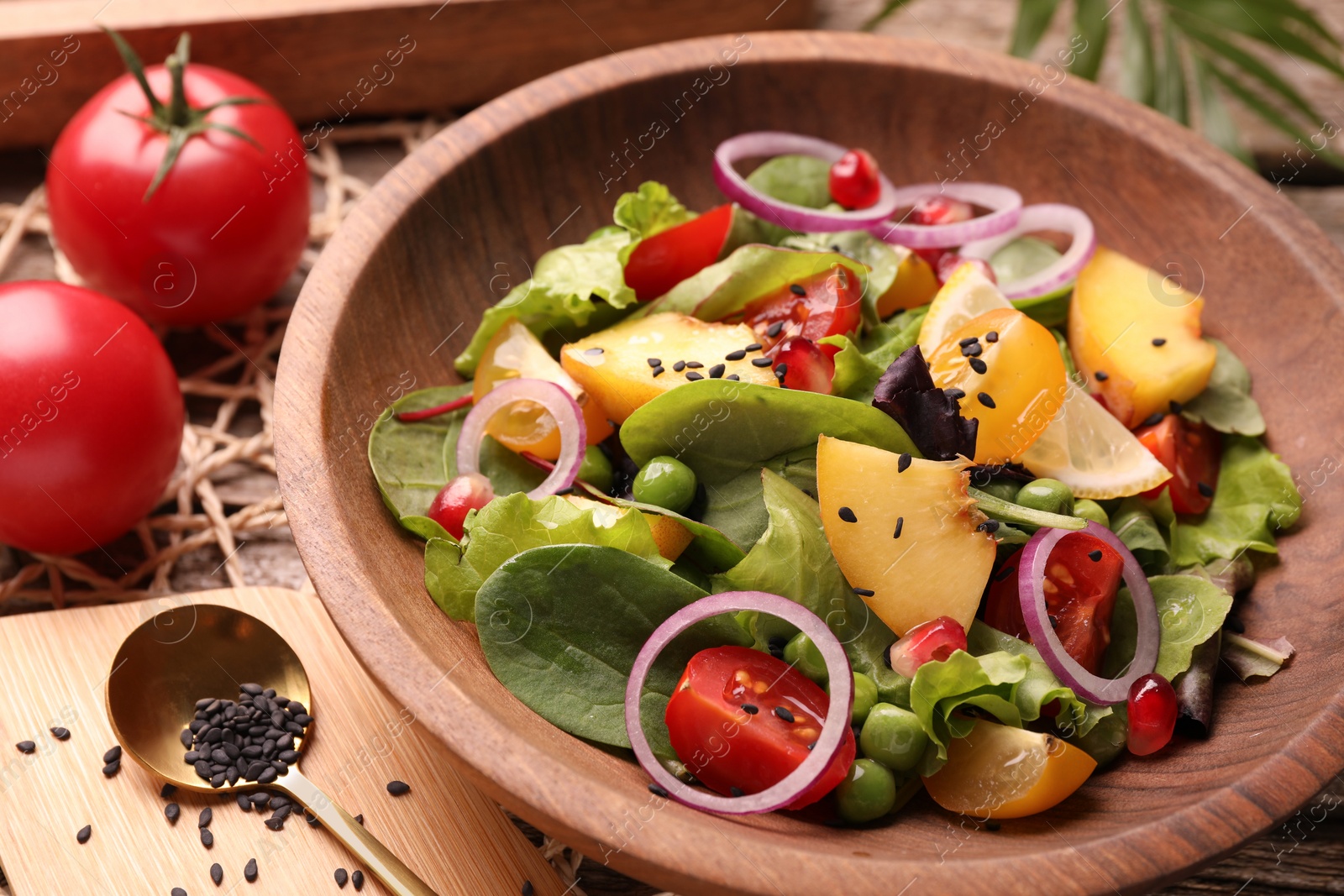 Photo of Delicious salad with peach, green peas and vegetables served on table, closeup