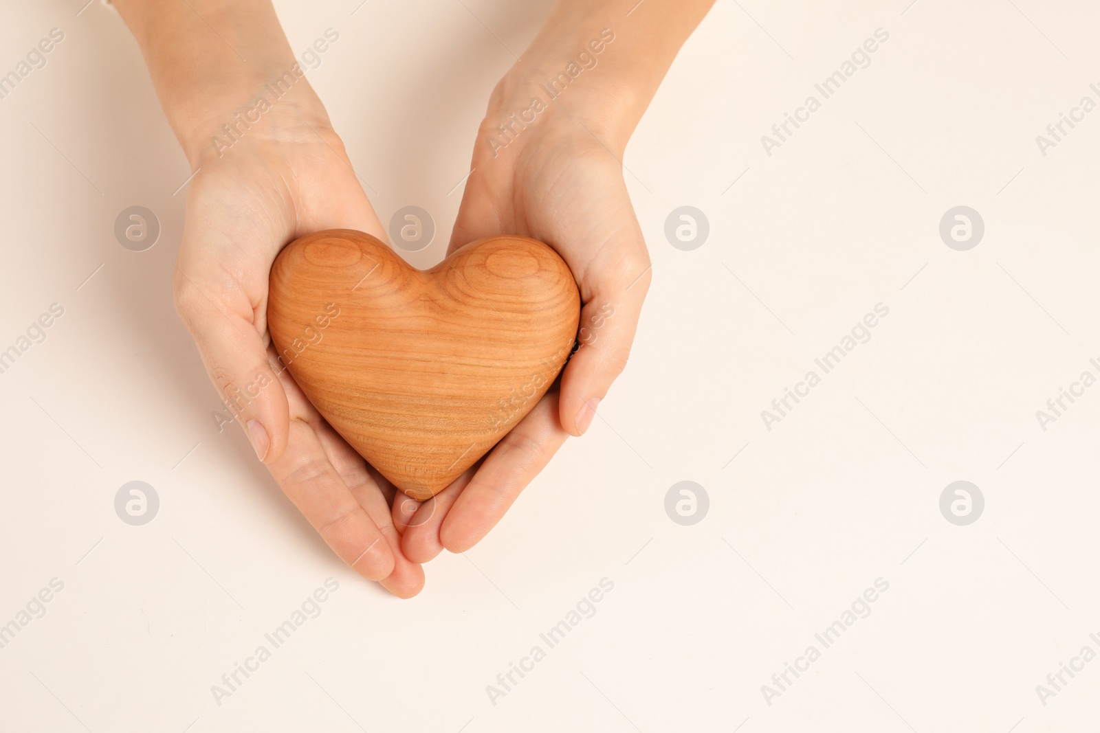 Photo of Woman holding decorative heart on white background, top view with space for text