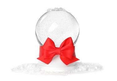 Magical empty snow globe with red bow on white background