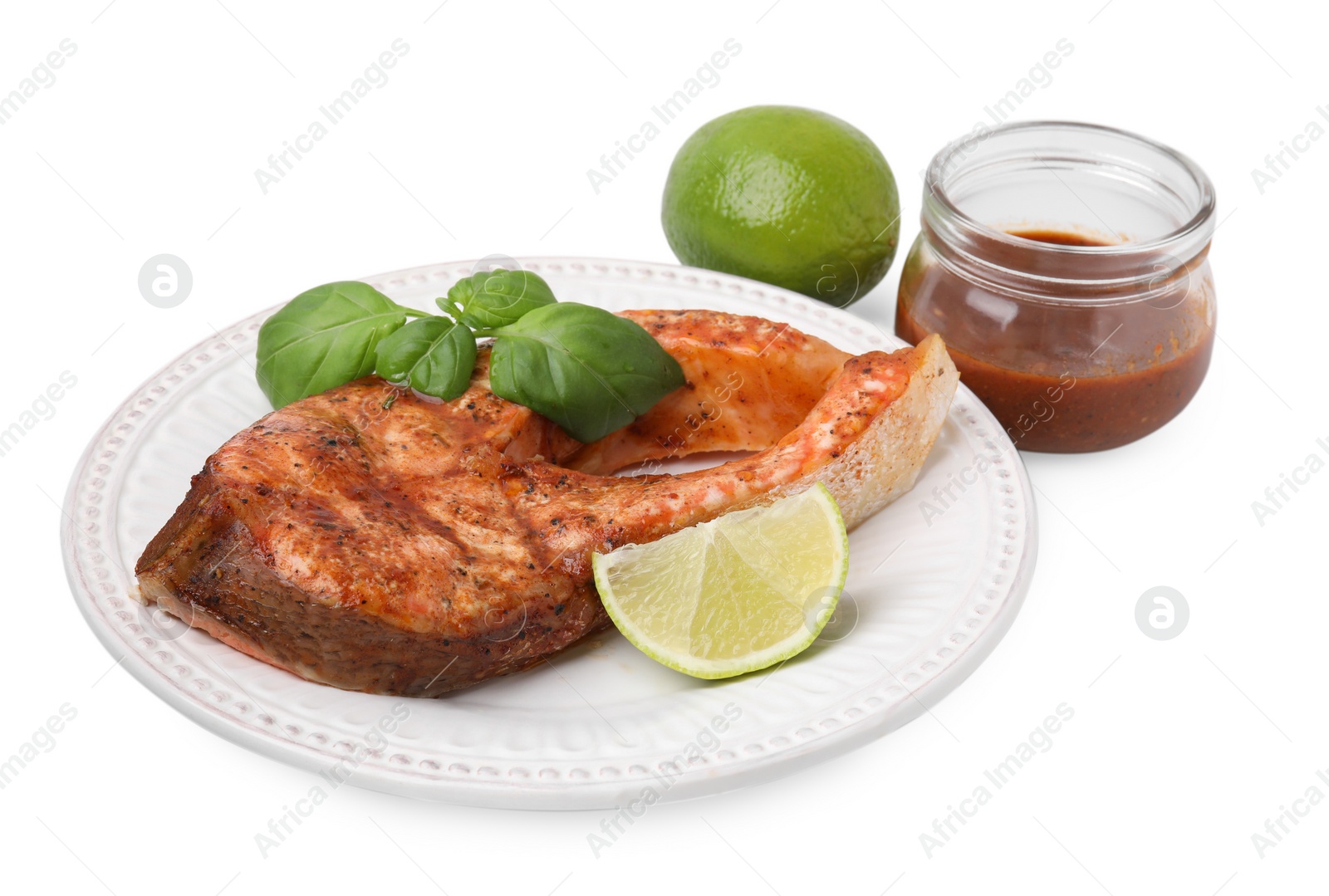 Photo of Fresh marinade, cooked fish, lime and basil isolated on white