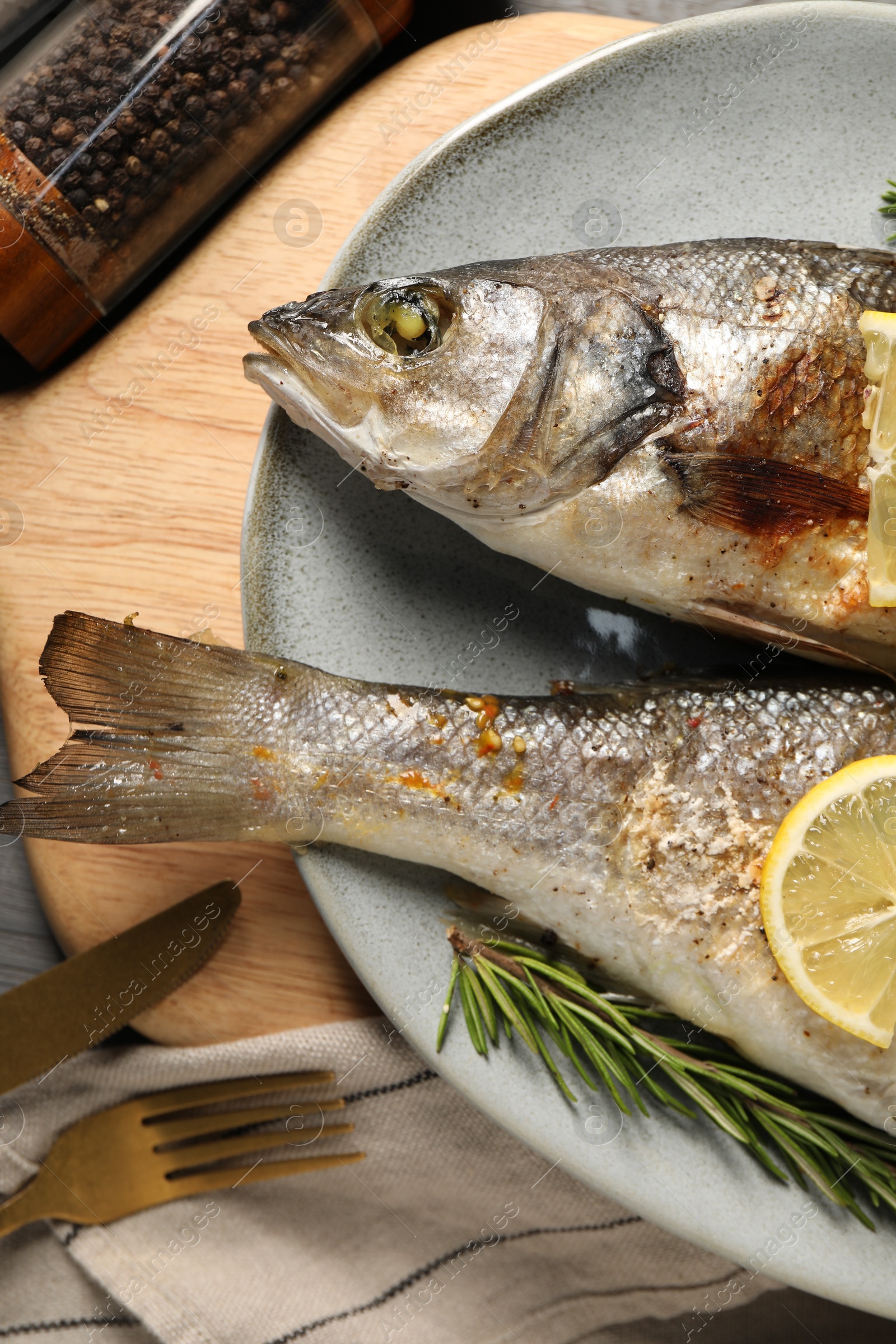 Photo of Delicious baked fish served on table, top view