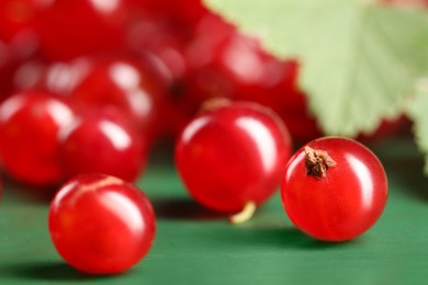 Photo of Ripe red currants on green table, closeup