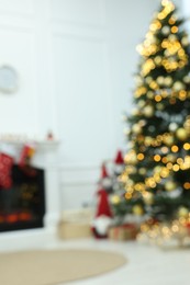 Photo of Blurred view of decorated Christmas tree in living room. Interior design