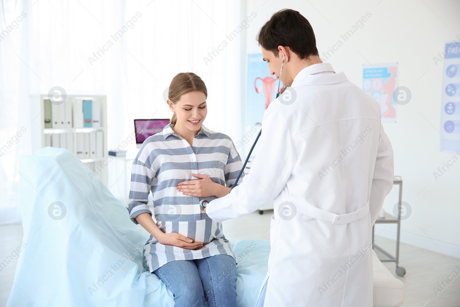 Photo of Gynecology consultation. Pregnant woman with her doctor in clinic