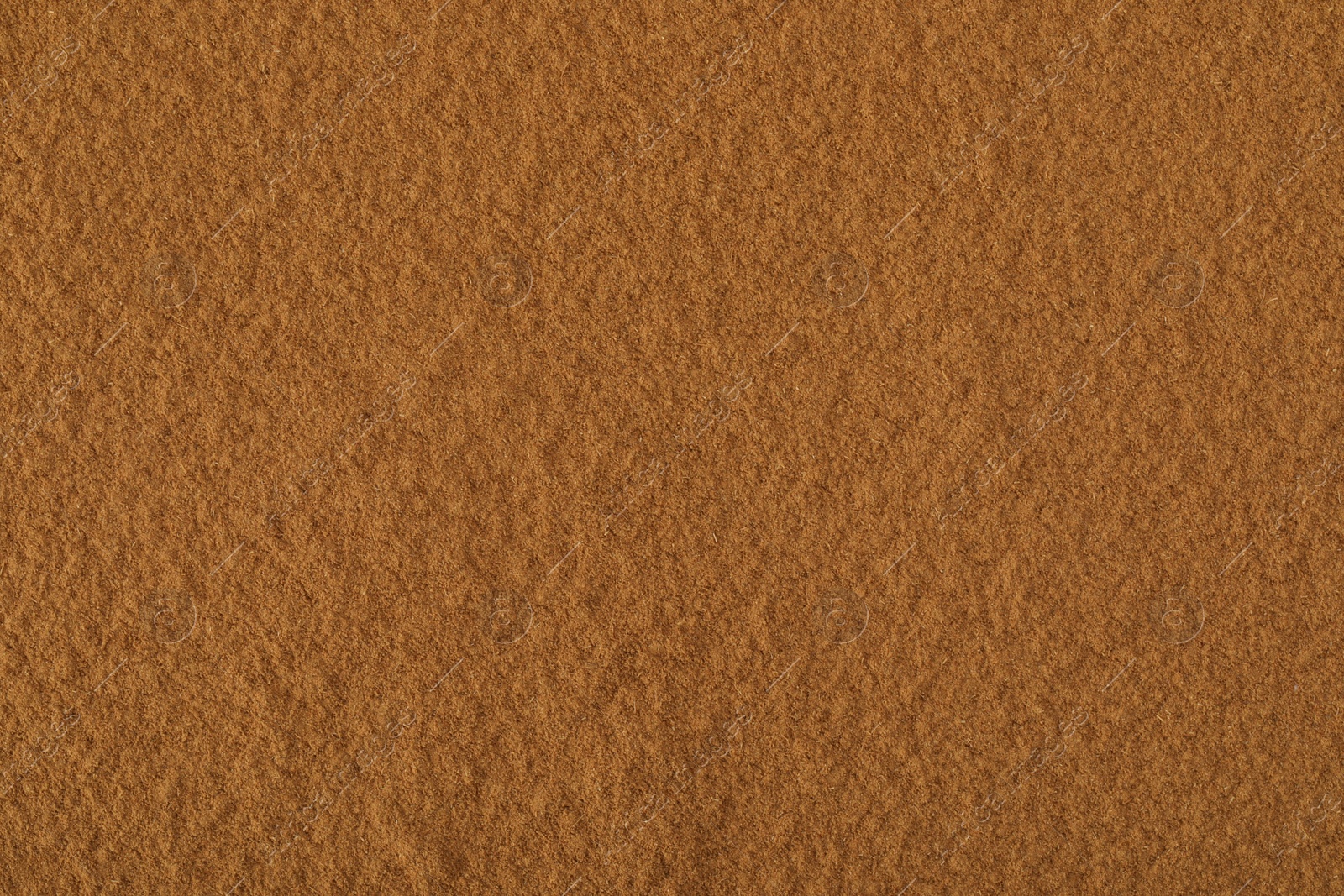 Photo of Dry aromatic cinnamon powder as background, top view