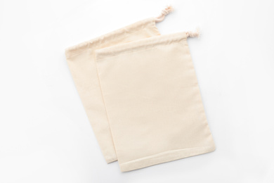 Photo of Cotton eco bags isolated on white, top view