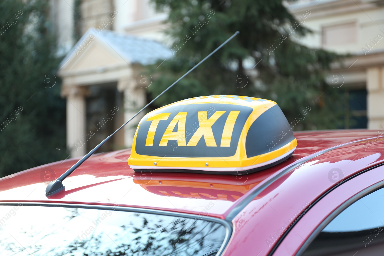 Photo of Roof light with word TAXI on car outdoors