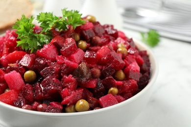 Photo of Traditional Russian salad vinaigrette in bowl, closeup