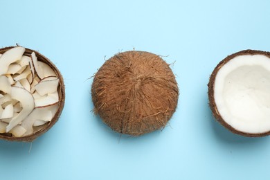 Photo of Flat lay composition with tasty coconut chips on light blue background