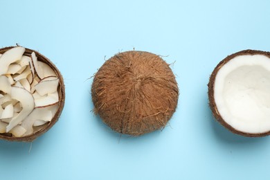 Flat lay composition with tasty coconut chips on light blue background