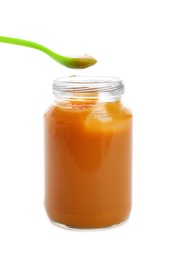 Photo of Jar and spoon with healthy baby food on white background