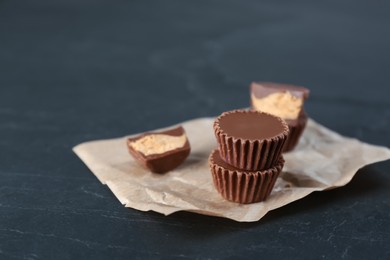 Delicious peanut butter cups on black table