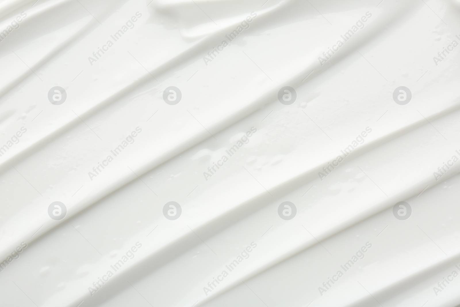 Photo of Texture of face care cream as background, top view