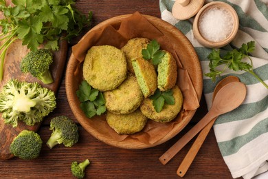Tasty vegan cutlets and ingredients on wooden table, flat lay
