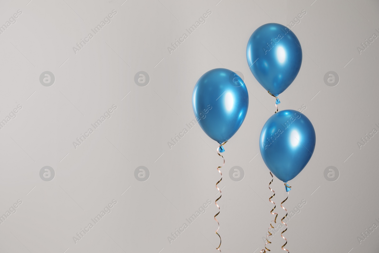 Photo of Bright balloons on light background. Space for text