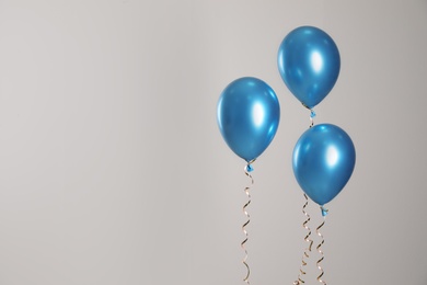 Photo of Bright balloons on light background. Space for text