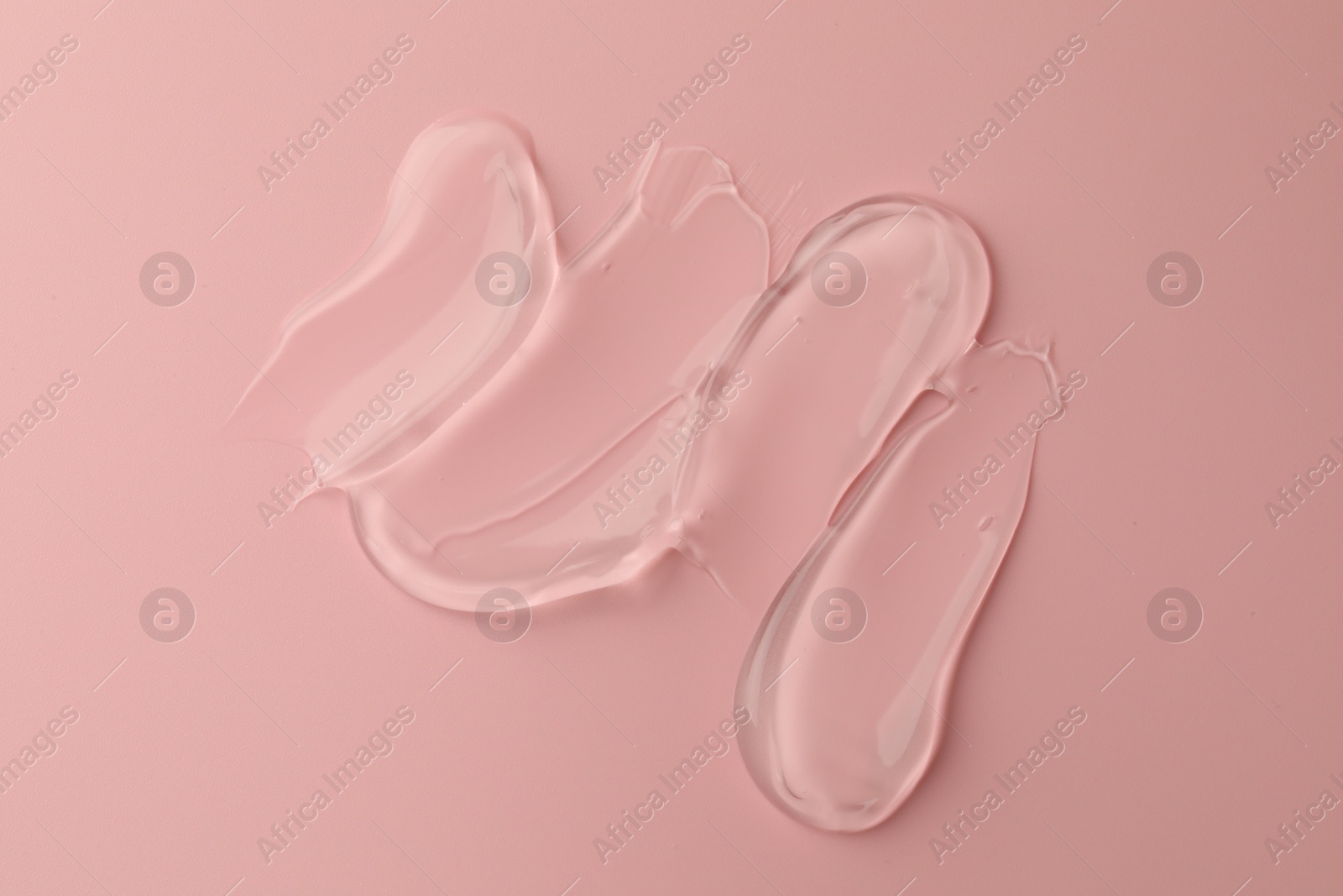 Photo of Sample of clear cosmetic gel on pink background, top view