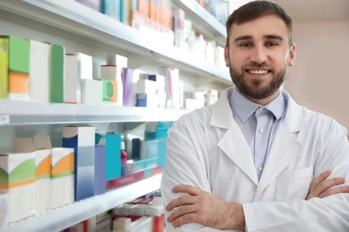 Photo of Professional pharmacist near shelves in modern drugstore