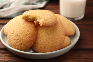 Photo of Delicious Danish butter cookies on wooden table, closeup