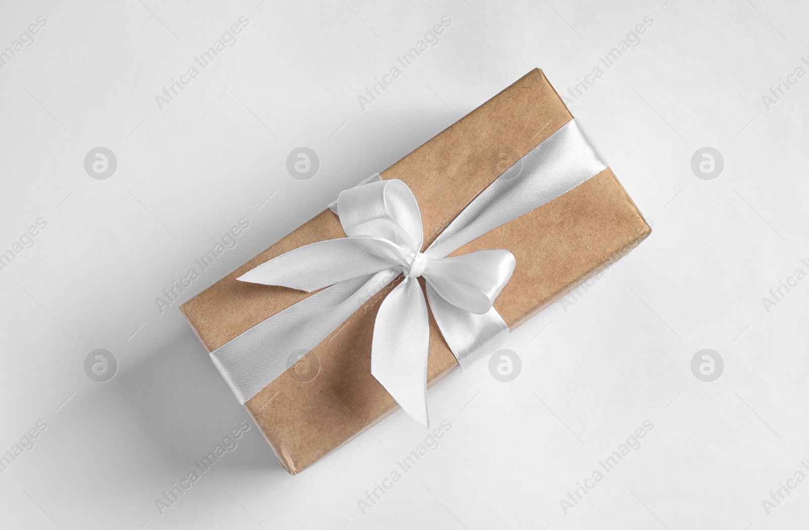 Photo of Beautifully wrapped gift box on white background, top view