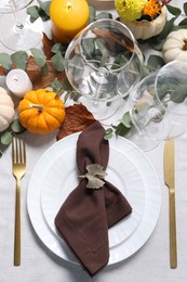 Photo of Beautiful autumn table setting. Plates, cutlery, glasses, pumpkins and floral decor, flat lay