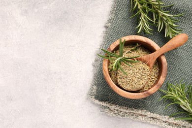 Photo of Fresh and dry rosemary on white textured table, flat lay. Space for text