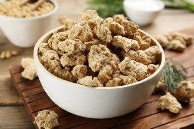 Photo of Dried soy meat on wooden table, closeup