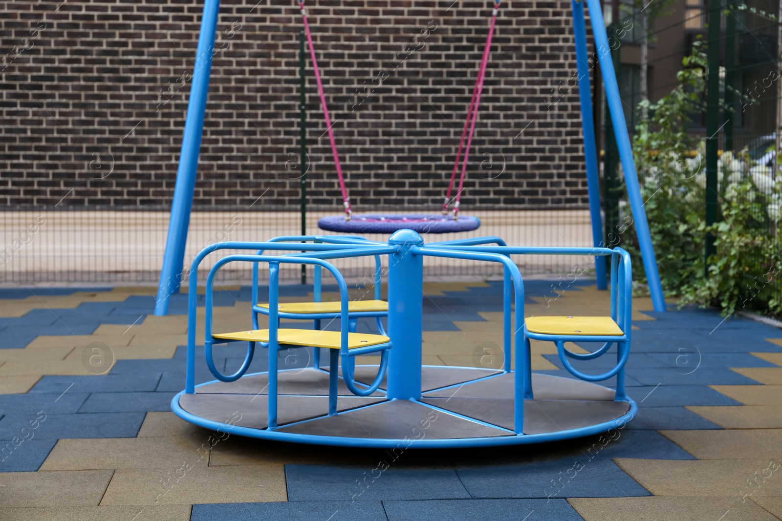 Photo of Colourful carousel for children on outdoor playground