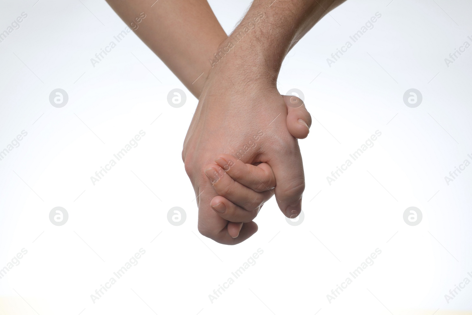 Photo of Man and woman holding hands together on white background, closeup