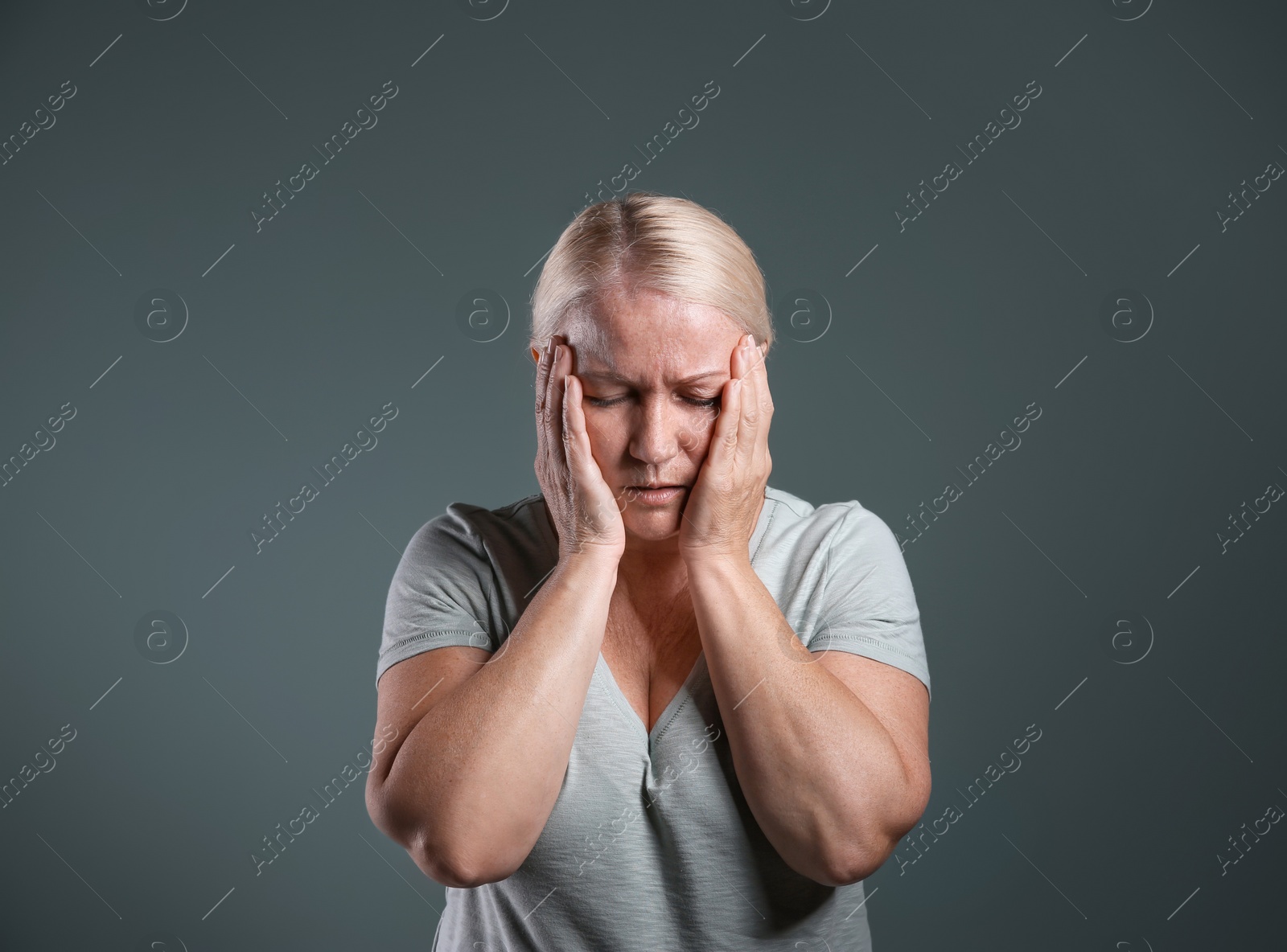 Photo of Mature woman suffering from depression on grey background