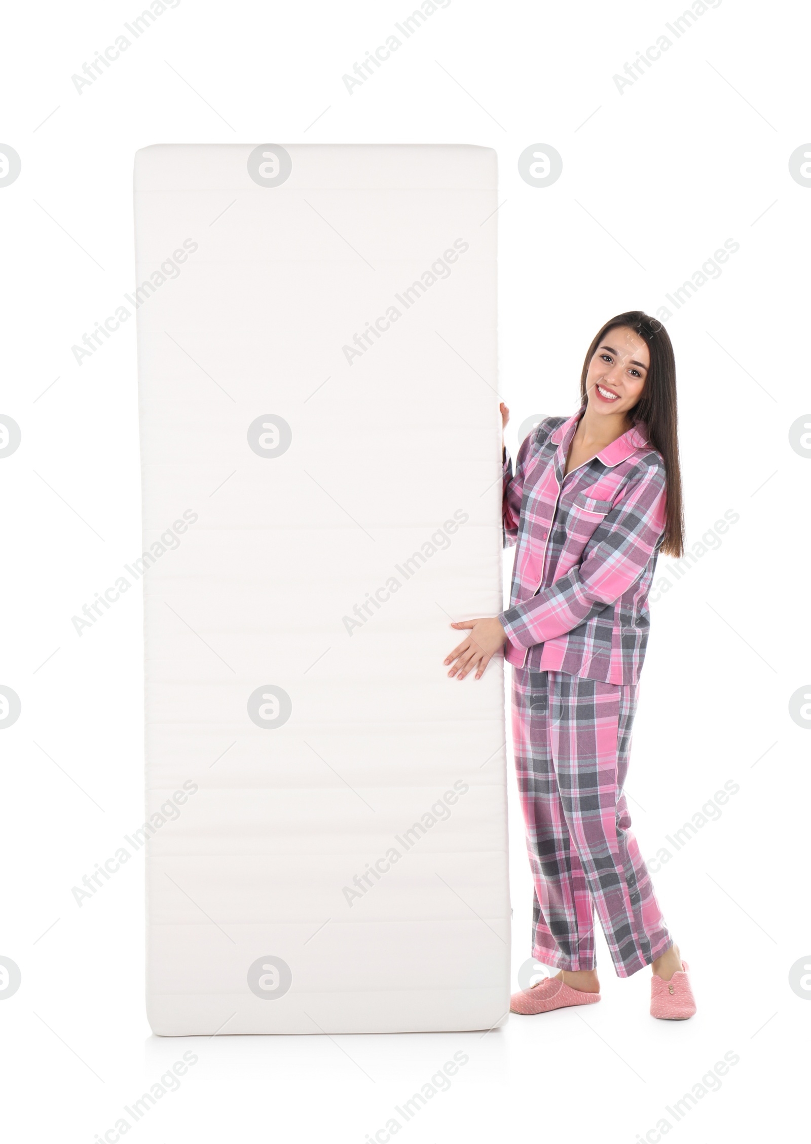 Photo of Young woman with comfortable mattress isolated on white