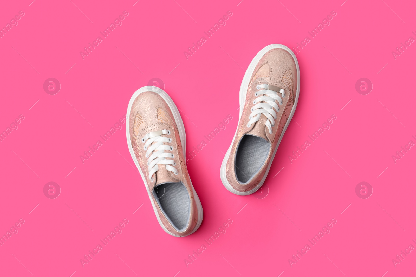 Photo of Stylish shoes on pink background, flat lay