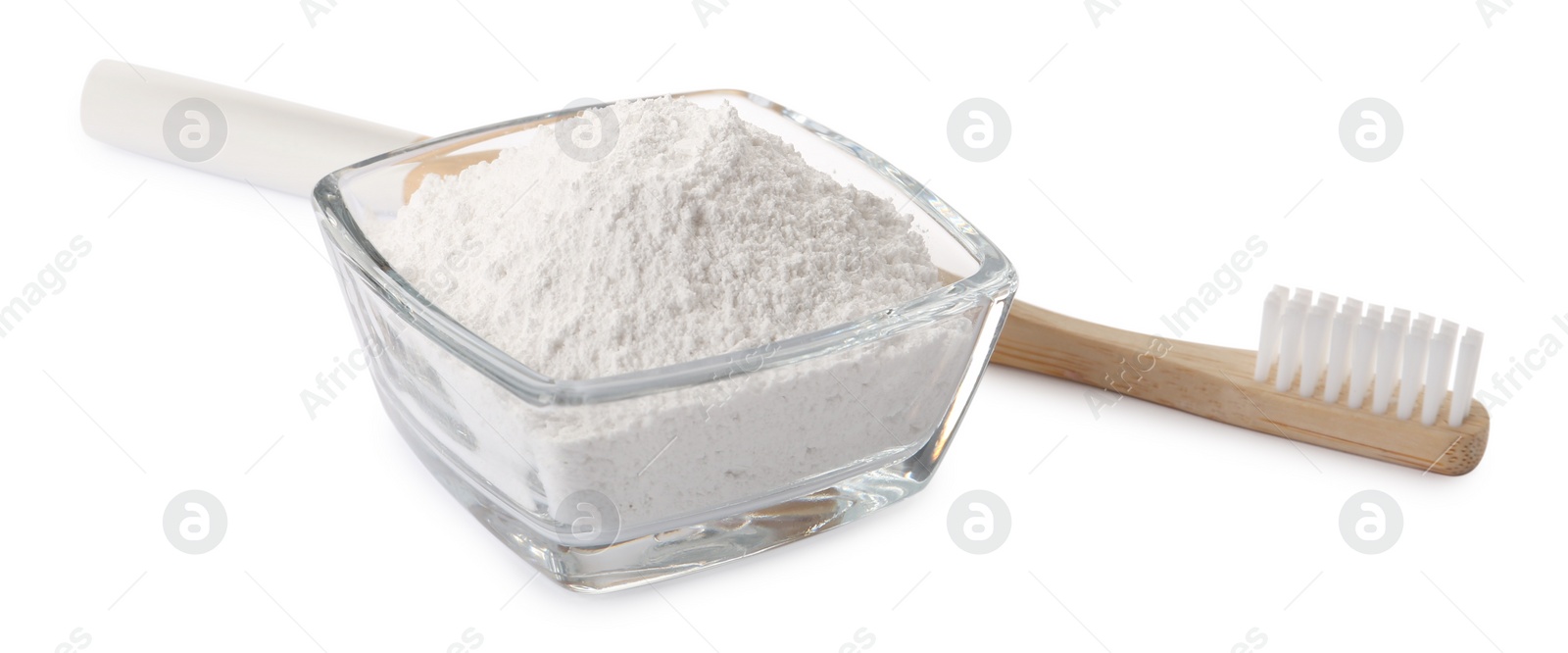 Photo of Glass bowl of tooth powder and brush on white background