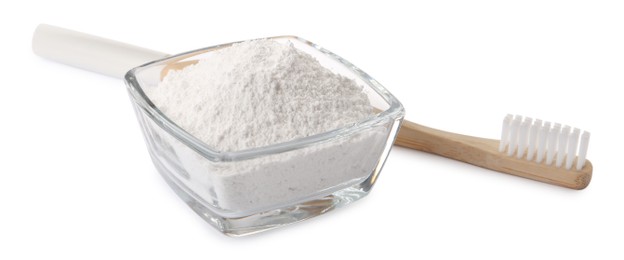 Photo of Glass bowl of tooth powder and brush on white background