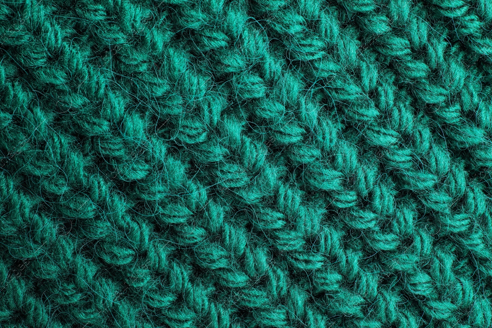 Photo of Green knitted sweater as background, closeup view