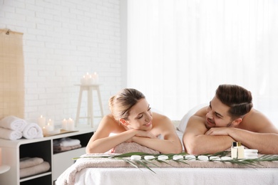 Photo of Romantic young couple relaxing in spa salon